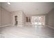 Open living room boasts light gray flooring, neutral walls, and bright light from the back patio at 3105 Birch Hill Ct, Las Vegas, NV 89134