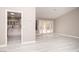 Open living room features gray flooring, neutral walls, and bright light from the kitchen and back patio at 3105 Birch Hill Ct, Las Vegas, NV 89134