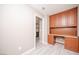 Built in office desk and cabinets with views to the kitchen and light grey flooring at 3105 Birch Hill Ct, Las Vegas, NV 89134