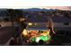 Aerial dusk view of a home with a backyard pool and patio, nestled in a quiet residential neighborhood at 3194 Lapis Beach Dr, Las Vegas, NV 89117