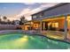 Backyard pool and patio with outdoor seating, garden, and twilight sky at 3194 Lapis Beach Dr, Las Vegas, NV 89117