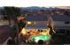 Stunning aerial view of a backyard oasis with a sparkling pool, covered patio, and lush landscaping at 3194 Lapis Beach Dr, Las Vegas, NV 89117