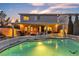 Glowing backyard pool and spa with covered patio, perfect for evening relaxation at 3194 Lapis Beach Dr, Las Vegas, NV 89117