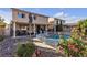 Charming backyard with pool, covered patio, and beautifully landscaped garden areas at 3194 Lapis Beach Dr, Las Vegas, NV 89117