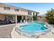 Home with a sparkling pool, spa, covered patio, outdoor kitchen, and lush landscaping at 3194 Lapis Beach Dr, Las Vegas, NV 89117