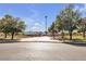 Neighborhood baseball field with well-maintained grounds, surrounded by mature trees under a clear blue sky at 3194 Lapis Beach Dr, Las Vegas, NV 89117
