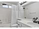 Bathroom featuring a bathtub-shower combination and single sink vanity with matte black hardware at 3194 Lapis Beach Dr, Las Vegas, NV 89117