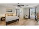 Spacious bedroom with hardwood floors, large windows, and a comfortable seating area at 3194 Lapis Beach Dr, Las Vegas, NV 89117