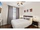 Cozy bedroom with hardwood floors, ceiling fan, a comfortable bed and ample natural light at 3194 Lapis Beach Dr, Las Vegas, NV 89117