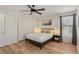 Cozy bedroom with hardwood floors, stylish lighting, and closet storage space at 3194 Lapis Beach Dr, Las Vegas, NV 89117