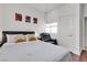 Bedroom with a queen bed, wood floors, accent wall art, and a reading chair at 3194 Lapis Beach Dr, Las Vegas, NV 89117