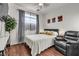 Cozy bedroom with hardwood floors, ceiling fan, and natural light at 3194 Lapis Beach Dr, Las Vegas, NV 89117
