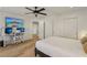 Comfortable bedroom with hardwood floors, large-screen TV, and a convenient home office space at 3194 Lapis Beach Dr, Las Vegas, NV 89117
