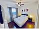 Cozy bedroom featuring a ceiling fan, window with curtains, and bedside tables with lamps at 3194 Lapis Beach Dr, Las Vegas, NV 89117