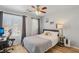 Bright bedroom features a ceiling fan, hardwood floors, and a view of the outdoors at 3194 Lapis Beach Dr, Las Vegas, NV 89117