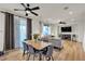 Open-concept dining area with hardwood floors, a modern table, and a view of the living room at 3194 Lapis Beach Dr, Las Vegas, NV 89117