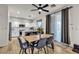 Bright dining area with hardwood floors, a modern table, and a view of the backyard at 3194 Lapis Beach Dr, Las Vegas, NV 89117