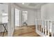 Bright hallway with wood floors, white walls, and stairs leading to the next level at 3194 Lapis Beach Dr, Las Vegas, NV 89117