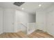 Bright hallway featuring hardwood floors and multiple doors, providing access to different rooms at 3194 Lapis Beach Dr, Las Vegas, NV 89117