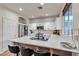 Modern kitchen with white cabinets, stainless appliances, large island, and bar stool seating at 3194 Lapis Beach Dr, Las Vegas, NV 89117