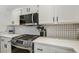 Modern kitchen features stainless steel gas range and white backsplash at 3194 Lapis Beach Dr, Las Vegas, NV 89117