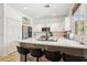 Kitchen features white cabinets, stainless appliances, quartz counters, breakfast bar seating at 3194 Lapis Beach Dr, Las Vegas, NV 89117
