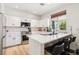 Kitchen boasts white cabinets, stainless appliances, quartz counters and breakfast bar seating at 3194 Lapis Beach Dr, Las Vegas, NV 89117