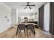Bright dining area with hardwood floors, a modern table set, and a view of the white kitchen at 3194 Lapis Beach Dr, Las Vegas, NV 89117