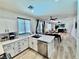 Bright modern kitchen featuring white cabinetry, stainless steel appliances, tile backsplash and breakfast bar at 3194 Lapis Beach Dr, Las Vegas, NV 89117