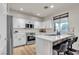 Bright kitchen boasts white cabinets, stainless steel appliances, and counter seating at 3194 Lapis Beach Dr, Las Vegas, NV 89117
