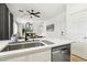 Open kitchen with quartz counters, stainless steel dishwasher, and modern faucet at 3194 Lapis Beach Dr, Las Vegas, NV 89117