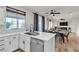 Open-concept kitchen with island and bar sink, connecting seamlessly to the dining and living areas at 3194 Lapis Beach Dr, Las Vegas, NV 89117