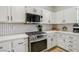 Kitchen features stainless steel appliances, white countertops, and a tiled backsplash at 3194 Lapis Beach Dr, Las Vegas, NV 89117