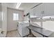 Functional laundry room featuring a modern washer and dryer, ample storage, and natural lighting at 3194 Lapis Beach Dr, Las Vegas, NV 89117