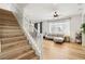 Bright living room featuring hardwood floors, a staircase, and a comfortable gray sofa set at 3194 Lapis Beach Dr, Las Vegas, NV 89117