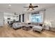 Open-concept living room with hardwood floors, a modern sofa, and a view of the kitchen at 3194 Lapis Beach Dr, Las Vegas, NV 89117