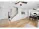 Open-concept living space with hardwood floors, a staircase, and a seamless flow to the kitchen at 3194 Lapis Beach Dr, Las Vegas, NV 89117