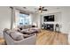 Cozy living room featuring hardwood floors, a modern sofa, and a television at 3194 Lapis Beach Dr, Las Vegas, NV 89117