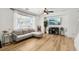 Comfortable living room features hardwood floors, a gray sofa set, and a large window with natural light at 3194 Lapis Beach Dr, Las Vegas, NV 89117