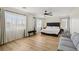 Spacious primary bedroom with hardwood floors, a ceiling fan and a luxurious bed with ample light at 3194 Lapis Beach Dr, Las Vegas, NV 89117