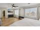 Spacious primary bedroom featuring hardwood floors, a wall mounted television, and a luxurious bed at 3194 Lapis Beach Dr, Las Vegas, NV 89117