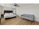 Spacious primary bedroom with hardwood floors, a comfortable couch and luxurious bed at 3194 Lapis Beach Dr, Las Vegas, NV 89117