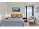 Serene bedroom with a plush bed, accent chair, and soft lighting, perfect for relaxation and rejuvenation at 3194 Lapis Beach Dr, Las Vegas, NV 89117