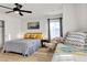 Comfortable bedroom with warm lighting, a queen bed, a daybed, and a relaxing sitting area at 3194 Lapis Beach Dr, Las Vegas, NV 89117
