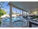 Inviting backyard with a covered patio, luxurious pool, and hot tub, perfect for entertaining and relaxation at 3194 Lapis Beach Dr, Las Vegas, NV 89117