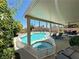 Backyard showcasing pool, spa, covered patio, and ample seating for outdoor enjoyment at 3194 Lapis Beach Dr, Las Vegas, NV 89117