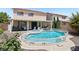 Beautiful backyard featuring a refreshing pool, spa, covered patio, and landscaped surroundings at 3194 Lapis Beach Dr, Las Vegas, NV 89117