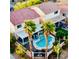 Aerial view of a backyard pool and jacuzzi with lounge chairs surrounded by palm trees in a well maintained yard at 3194 Lapis Beach Dr, Las Vegas, NV 89117