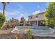 Inviting backyard pool and spa surrounded by lush landscaping and a white picket fence at 3194 Lapis Beach Dr, Las Vegas, NV 89117