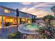 Backyard pool and spa with covered patio and clear view of the neighborhood at dusk at 3194 Lapis Beach Dr, Las Vegas, NV 89117